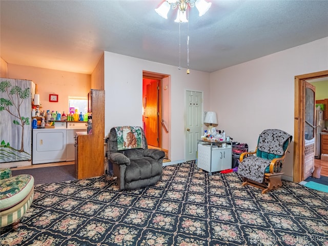 living room with a textured ceiling, separate washer and dryer, and ceiling fan