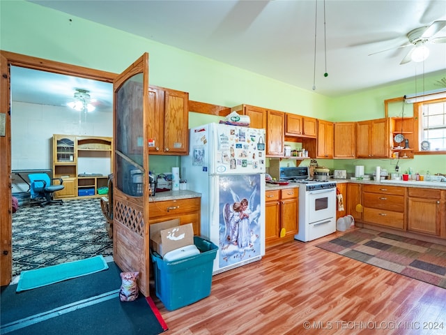 kitchen featuring ceiling fan, light hardwood / wood-style flooring, and white appliances