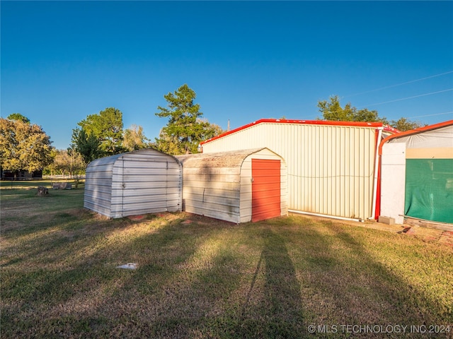 view of outbuilding featuring a yard