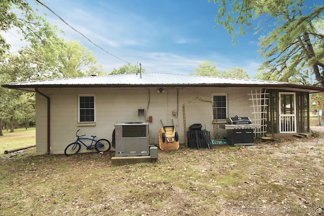 back of property featuring a yard