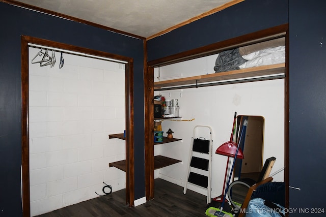 basement with crown molding and dark hardwood / wood-style floors