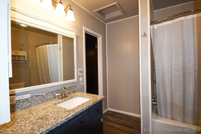 full bathroom with vanity, hardwood / wood-style floors, toilet, and shower / tub combo