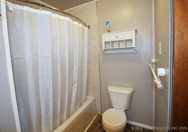 bathroom with shower / tub combo with curtain and toilet