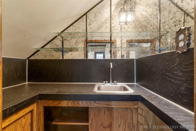 interior space featuring lofted ceiling and a sink