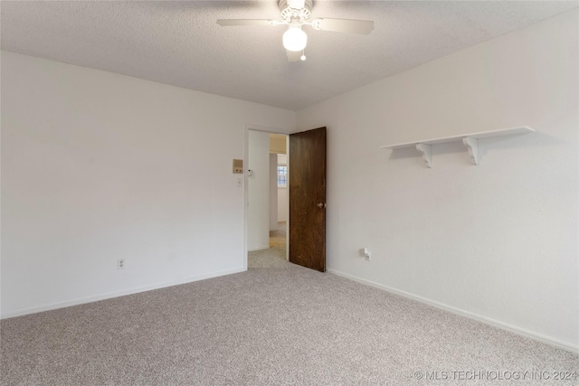 spare room with ceiling fan, carpet floors, and a textured ceiling