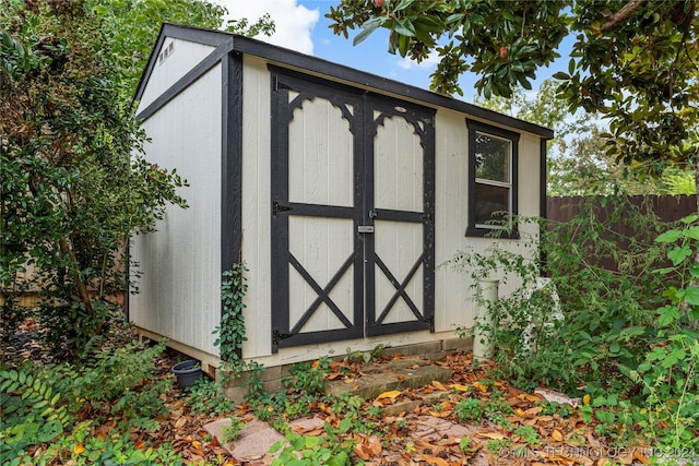 view of shed with fence