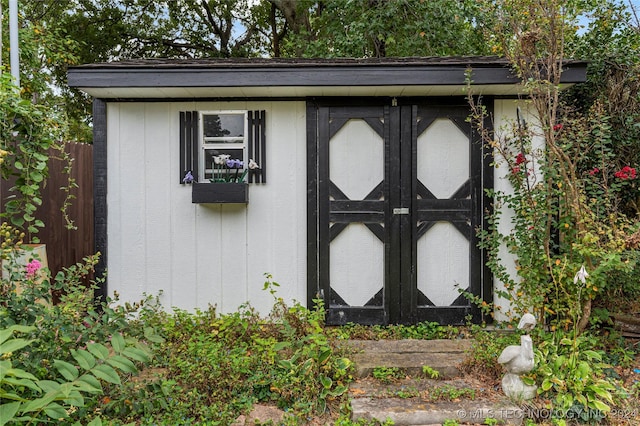 view of shed with fence