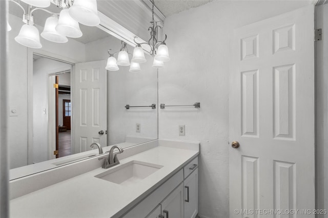 bathroom with a chandelier and vanity