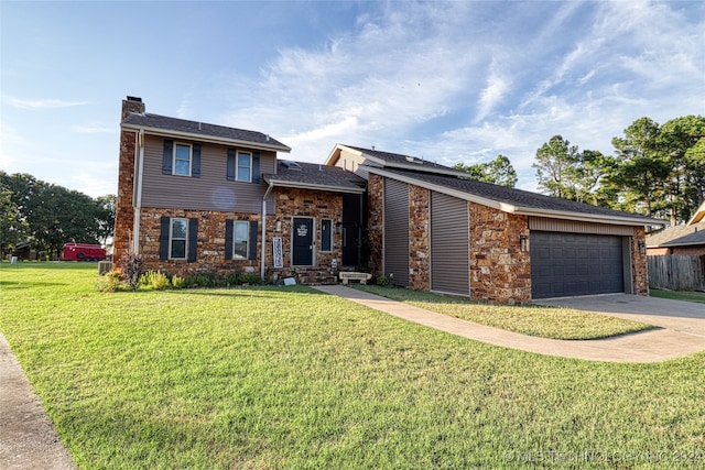 view of front of property featuring a front lawn and a garage