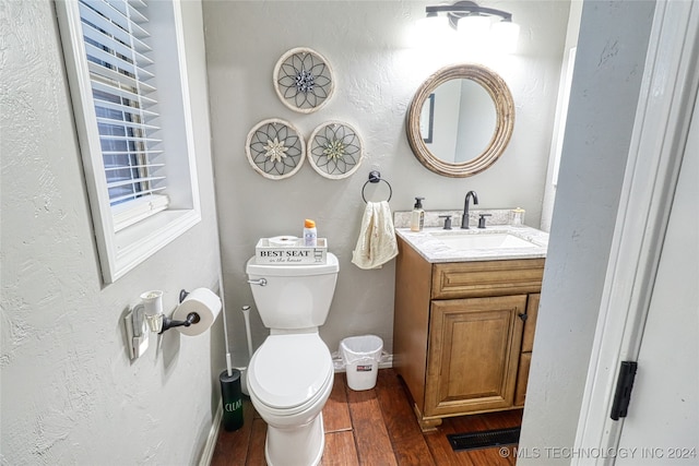 bathroom with vanity, hardwood / wood-style floors, and toilet