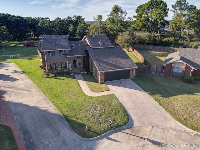 view of front of home with a front yard and a garage