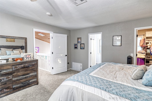 carpeted bedroom with a textured ceiling