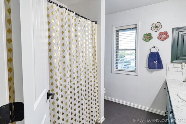 bathroom with hardwood / wood-style floors, vanity, and a shower with curtain