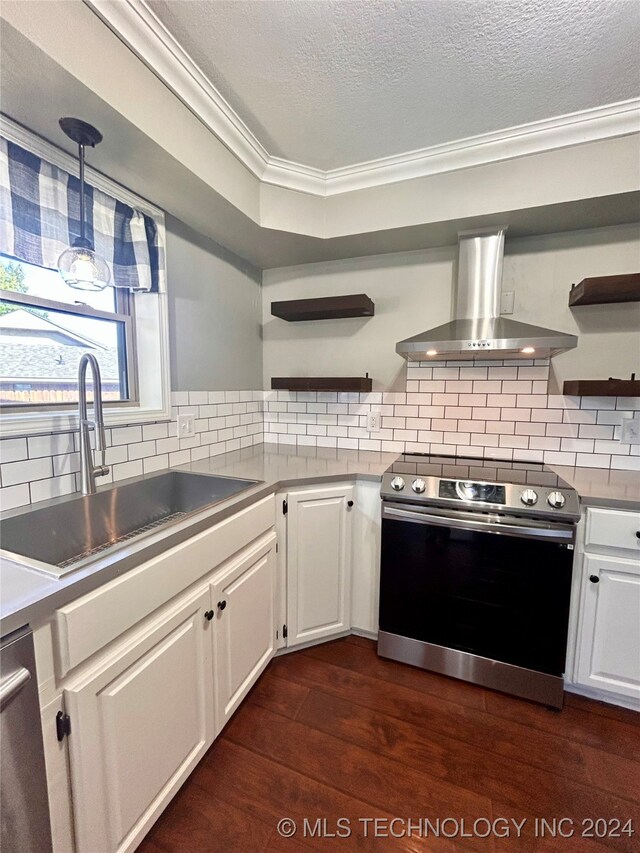 kitchen featuring dark hardwood / wood-style flooring, white cabinetry, wall chimney exhaust hood, and stainless steel appliances