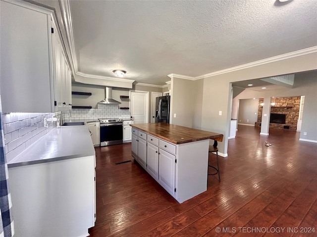 kitchen with wall chimney exhaust hood, dark hardwood / wood-style floors, stainless steel electric stove, black fridge with ice dispenser, and a kitchen island