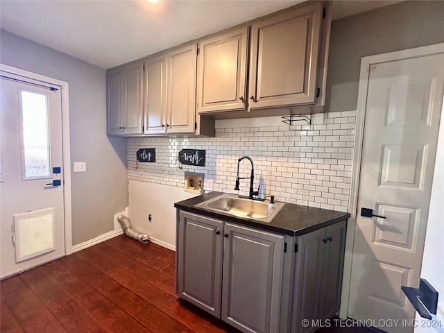 kitchen with sink, dark hardwood / wood-style floors, and tasteful backsplash