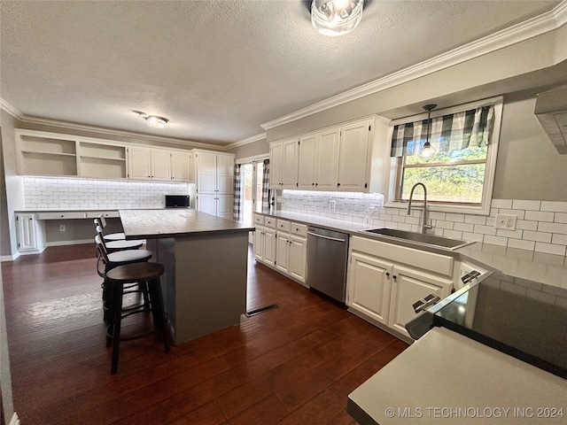 kitchen featuring a wealth of natural light, a center island, dark hardwood / wood-style floors, and stainless steel dishwasher