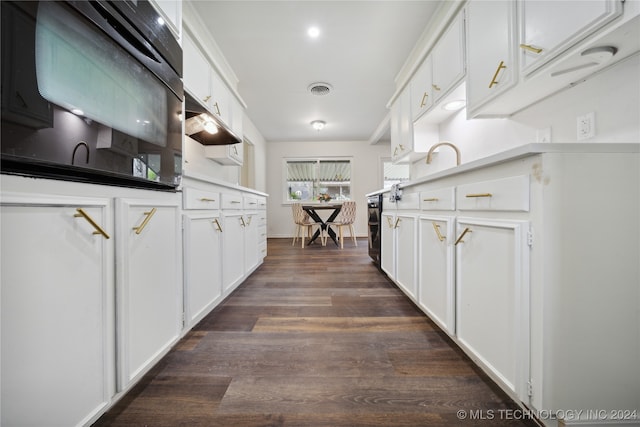 kitchen featuring white cabinets, oven, beverage cooler, and dark hardwood / wood-style floors