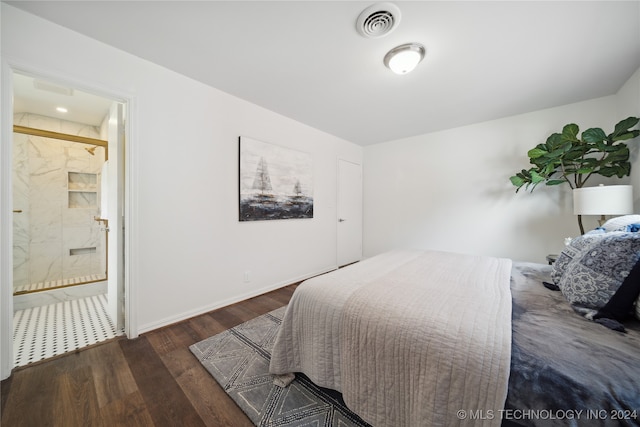 bedroom featuring ensuite bathroom and dark hardwood / wood-style flooring