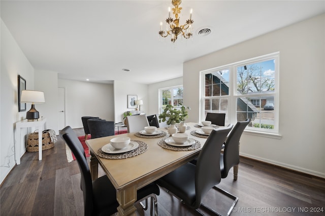 dining room with an inviting chandelier and dark hardwood / wood-style flooring