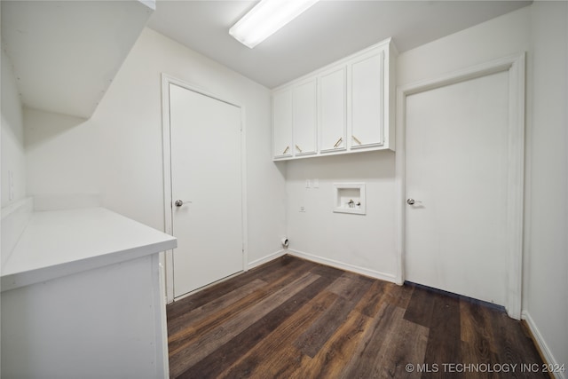 clothes washing area featuring washer hookup, cabinets, and dark wood-type flooring