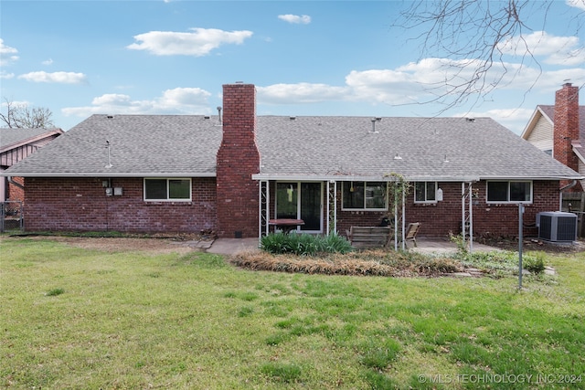 back of property featuring a lawn, a patio, and central air condition unit