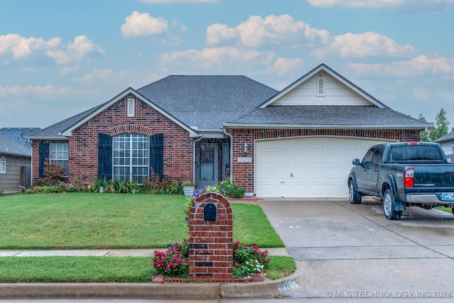 single story home featuring a garage and a front lawn