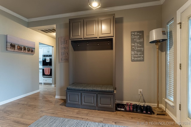 mudroom with light hardwood / wood-style flooring and crown molding