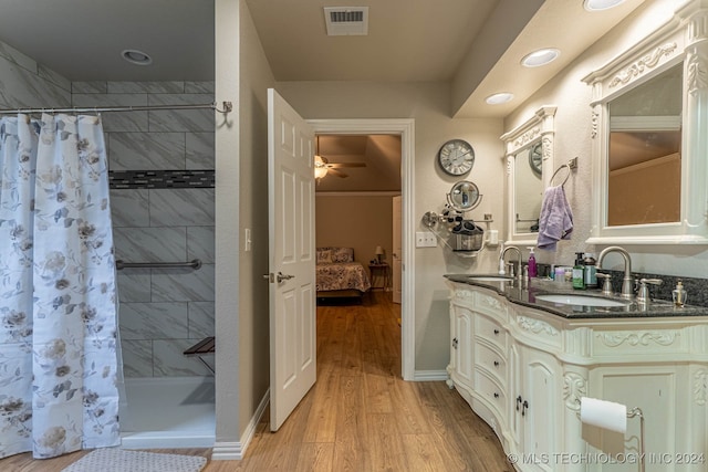 bathroom featuring a shower with shower curtain, hardwood / wood-style floors, and vanity