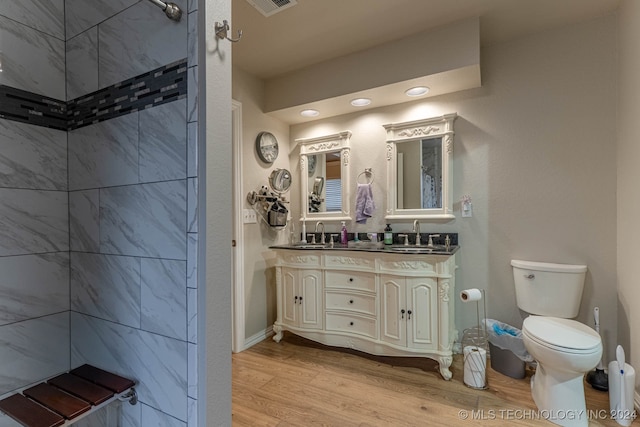 bathroom with hardwood / wood-style flooring, vanity, and toilet