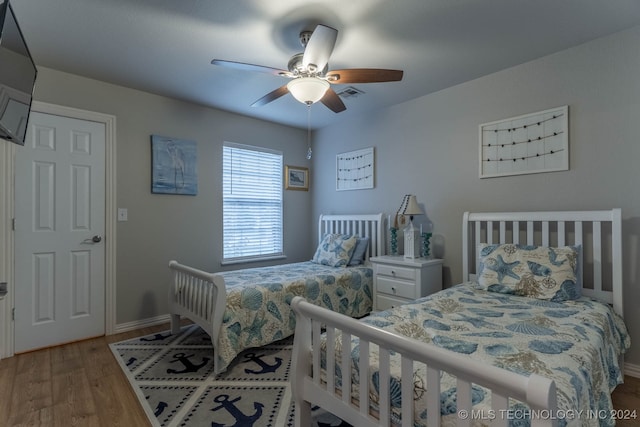 bedroom featuring ceiling fan and light wood-type flooring