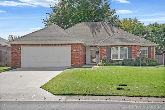 ranch-style home with a front yard and a garage