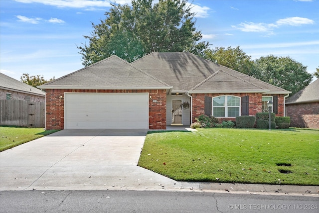 single story home with a front lawn and a garage