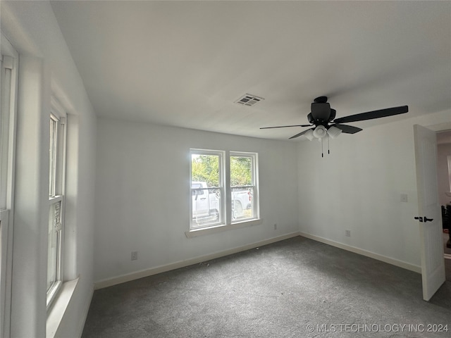 carpeted spare room featuring ceiling fan