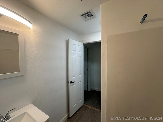 bathroom with hardwood / wood-style floors and sink