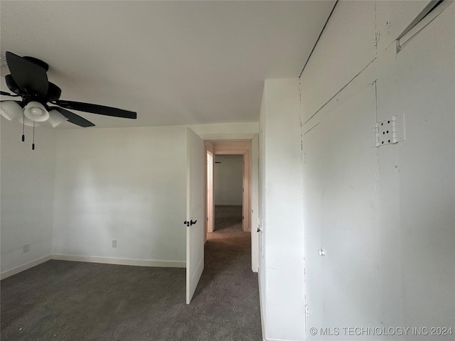 carpeted empty room featuring ceiling fan