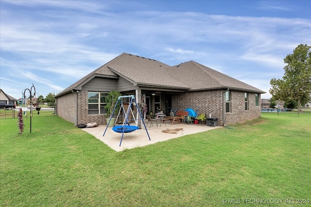 rear view of property with a patio and a yard