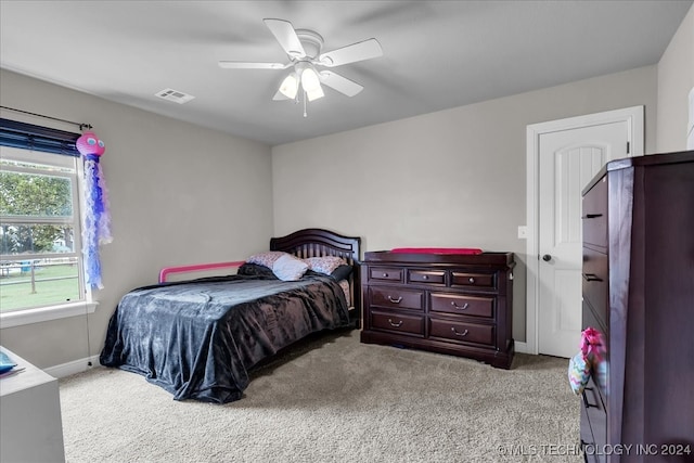 bedroom featuring light carpet and ceiling fan