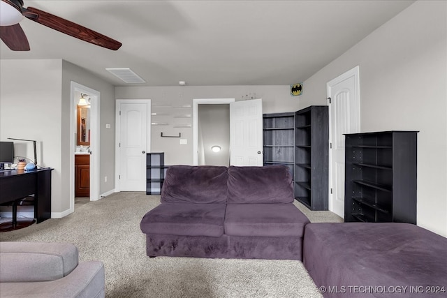 carpeted living room with ceiling fan