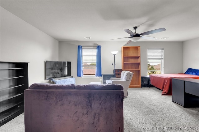 carpeted living room featuring ceiling fan and a healthy amount of sunlight