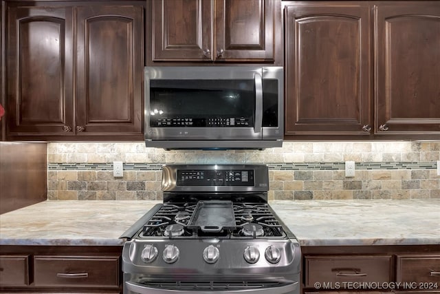 kitchen featuring dark brown cabinets, stainless steel appliances, and tasteful backsplash