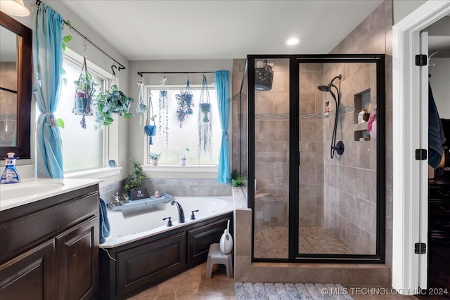 bathroom featuring shower with separate bathtub, vanity, and a wealth of natural light