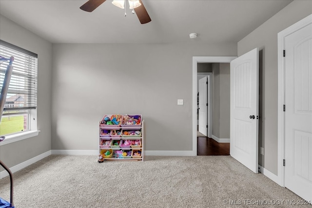 playroom featuring ceiling fan and carpet flooring