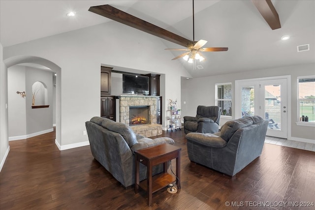 living room featuring dark wood-type flooring, beam ceiling, a fireplace, high vaulted ceiling, and ceiling fan