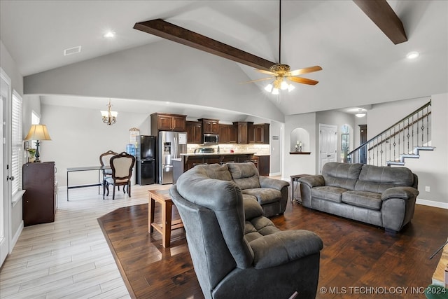 living room featuring ceiling fan with notable chandelier, light wood-type flooring, beam ceiling, and high vaulted ceiling