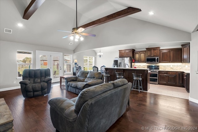 living room featuring ceiling fan with notable chandelier, dark hardwood / wood-style floors, beamed ceiling, and high vaulted ceiling