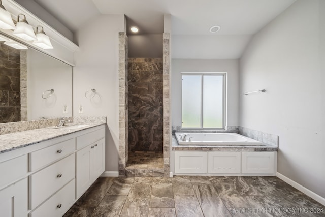 bathroom with independent shower and bath, vanity, and lofted ceiling