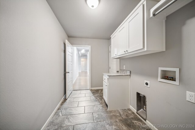 washroom featuring hookup for a washing machine, electric dryer hookup, and cabinets