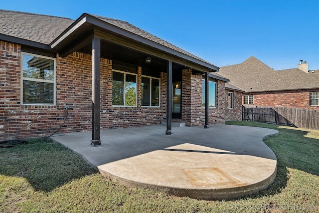 back of property featuring a lawn and a patio