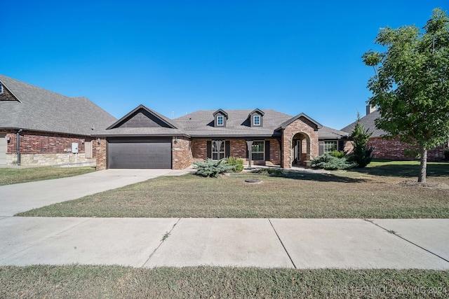 view of front of property featuring a garage and a front yard